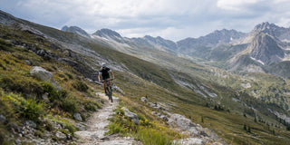 Cyclist riding a rugged mountain trail in outdoor sports sunglasses