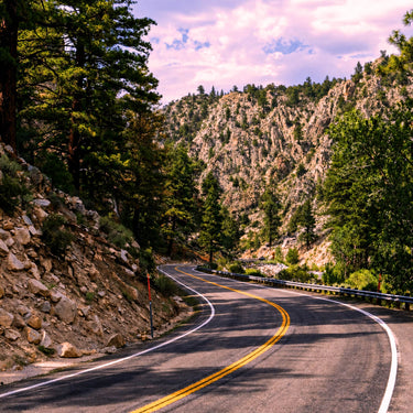 Mountain road with enhanced colors and improved contrast when viewed through color enhancing sunglasses.